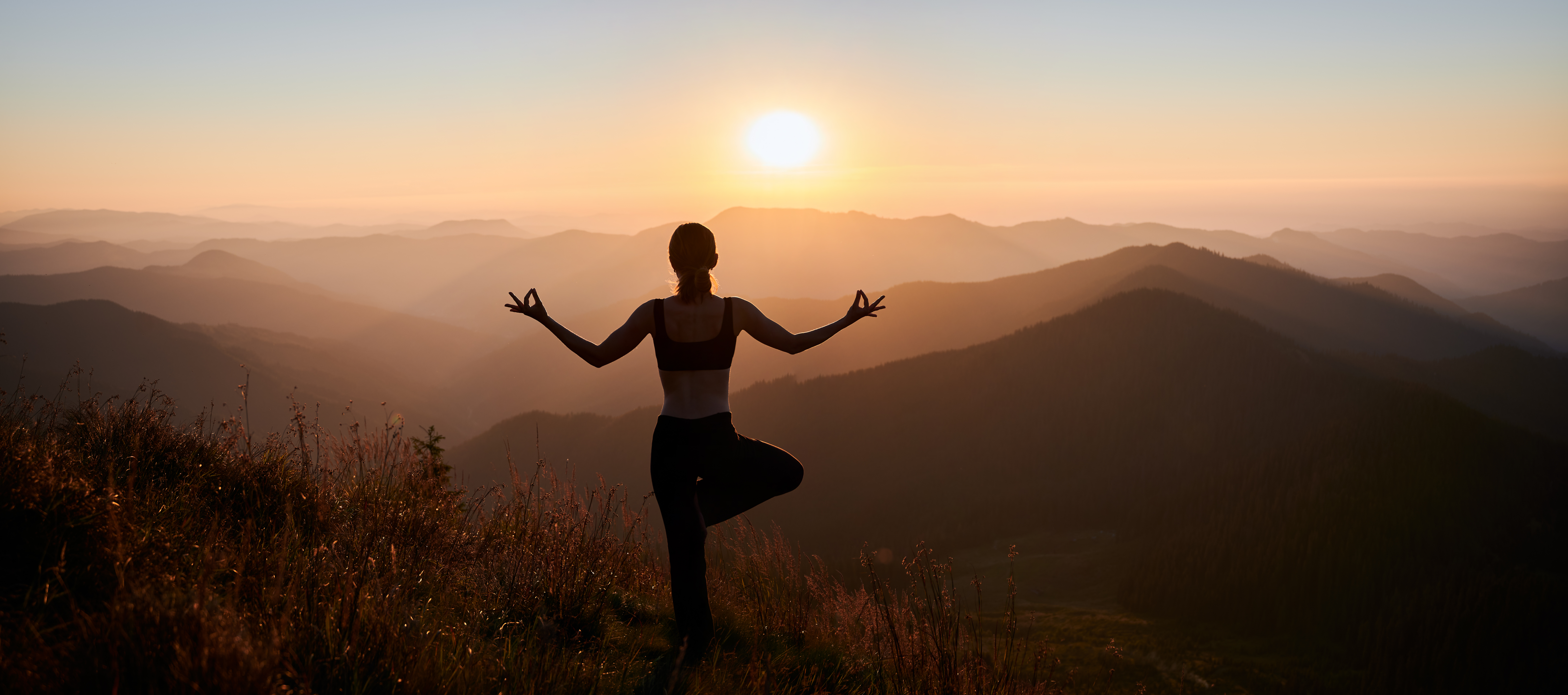 Diverse group practicing yoga and meditation together outdoors